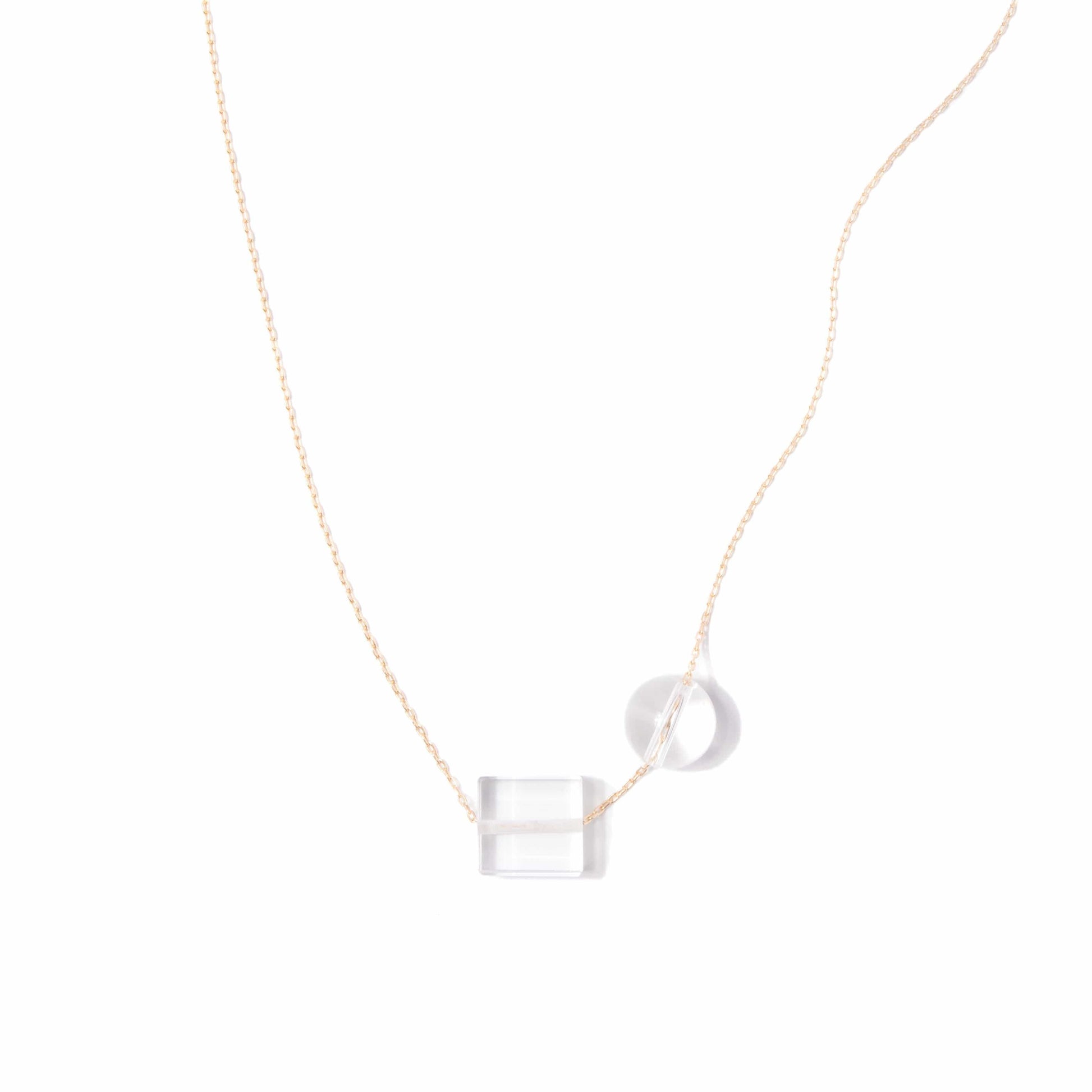 Michelle Starbuck Designs clear crystal quartz square and round beads with thin gold plated brass chain on white background