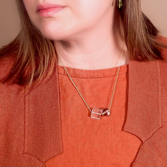 clear crystal quartz bead necklace worn by model with red color top
