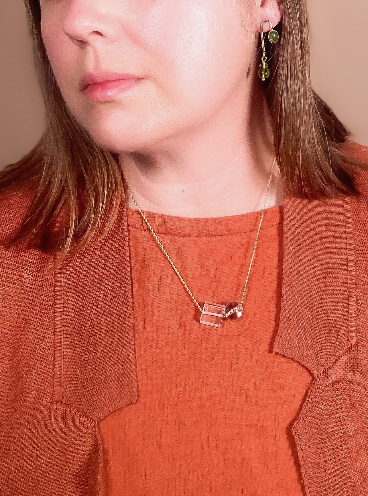 clear crystal quartz bead necklace worn by model with red color top