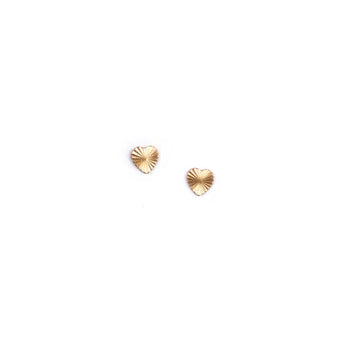 A pair of small gold-colored starburst heart-shaped stud earrings on a white background
