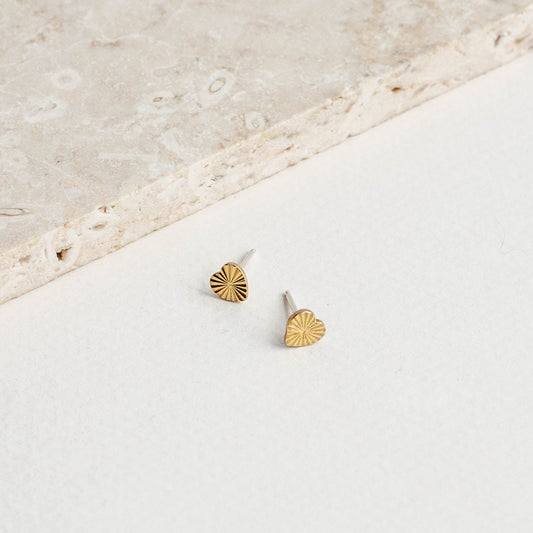 brass gold colored heart stud earrings with a starburst pattern